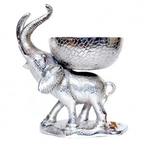 Elephant Bowl - Liberty Recycled Aluminium - Standing Elephant carrying a bowl: This divinely eccentric yet simple statement piece is made from beaten recycled aluminium by skilled craftsman The pitted, textured appearance adds a point of interest to the design giving each individual piece a unique character Lavishly popular up and down the land this lovely elephant bowl includes Free UK P&P *Main land only and currently excludes N.I Approximately 39 high, then 58 wide x 44 centimetres in depth – (H 39 x W 58 x D 44 cm) The price is for one piece, and please allow 14 : 21 days for dispatch from the point of purchase This amazing Liberty Recycled Aluminium Elephant Bowl is proudly “Sustainable, Affordable & Uniquely Different.”